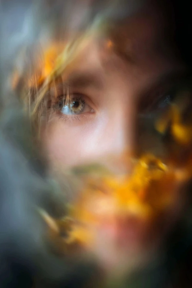 Golden Gaze Through Flora - Image 1
