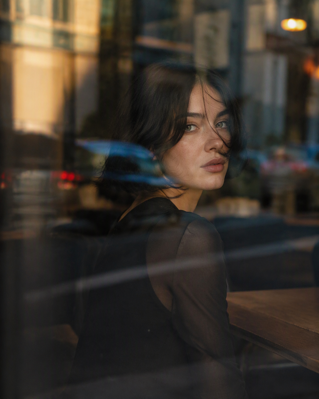 Ultra-cinematic close-up portrait of a young woman sittin...