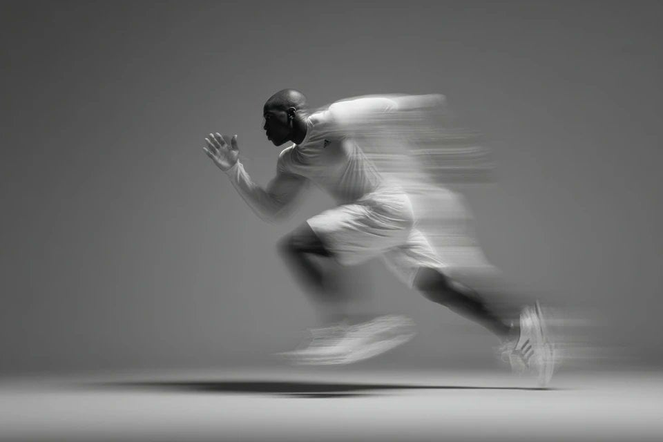 A blurred silhouette of a [Subject] in motion, wearing a ... - alternate