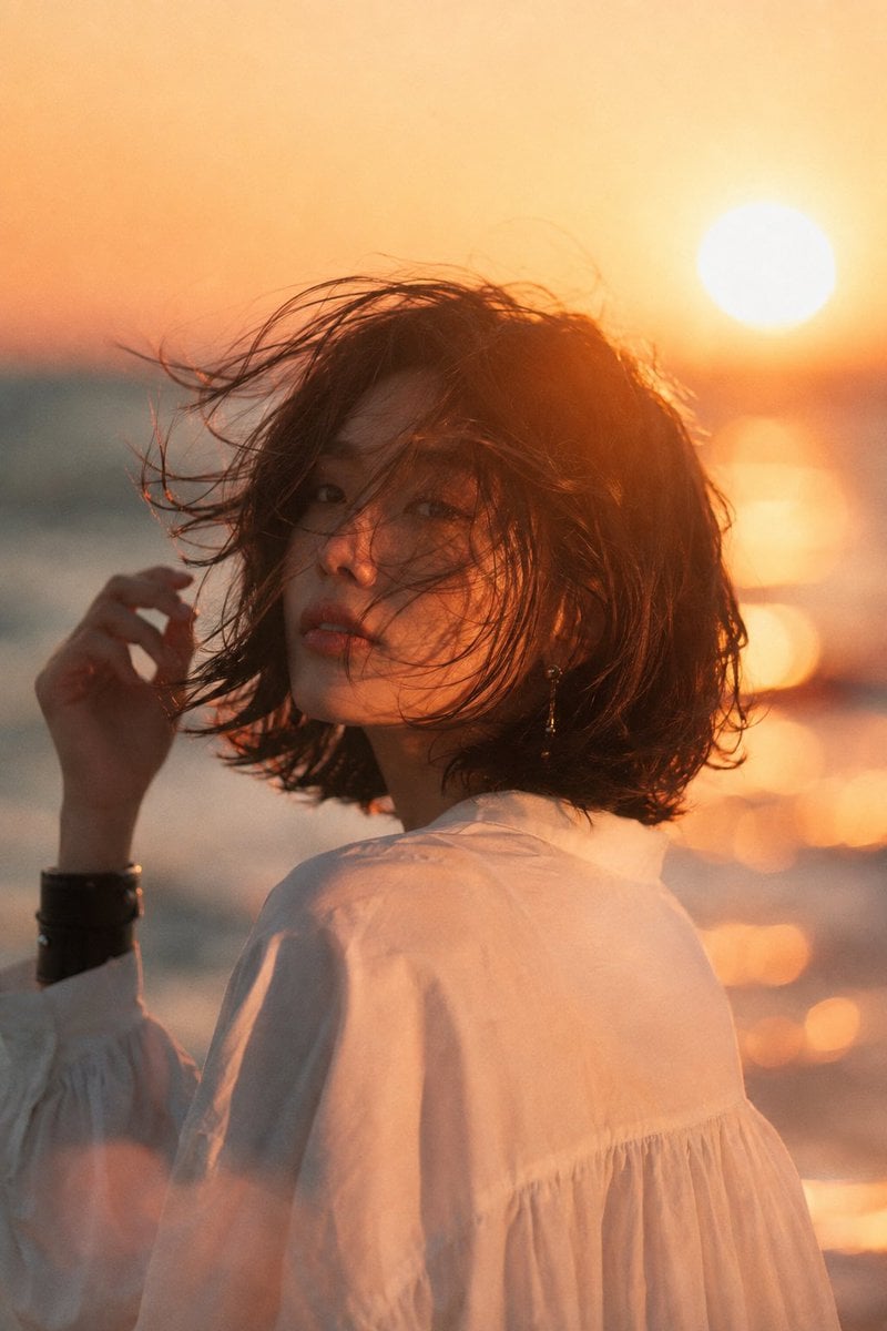 Beautiful young Asian woman at beach sunset, medium shot ... - alternate