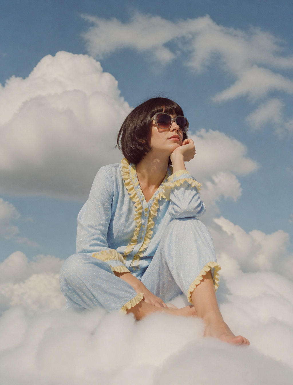 Photo of an eccentric woman sitting on top of white fluff...