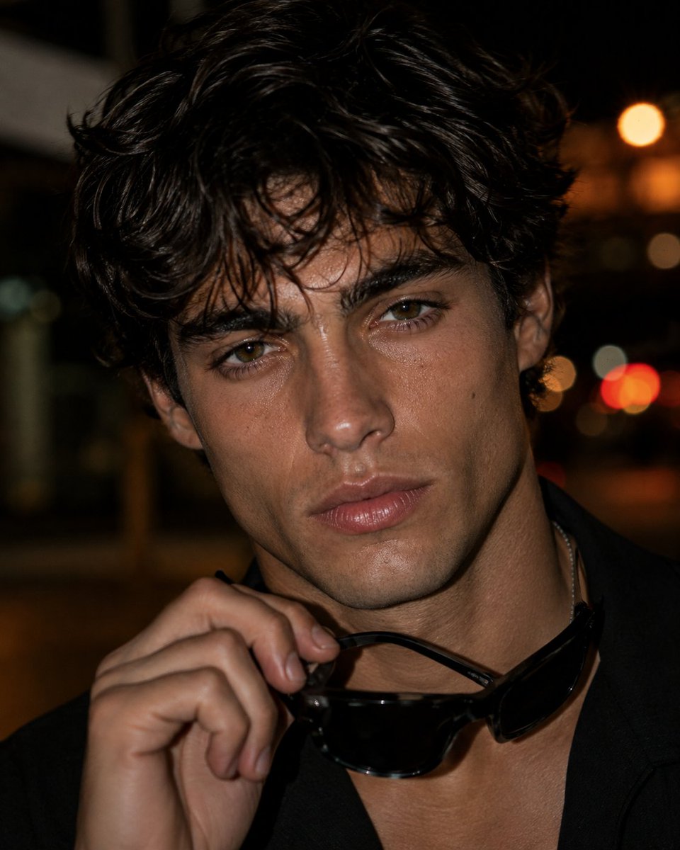 Photorealistic close-up editorial portrait of a young adu...