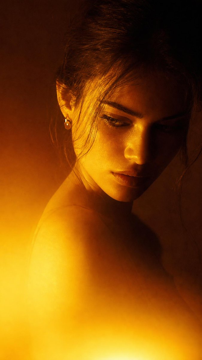 Dramatic close-up portrait with warm colored lighting, a ...