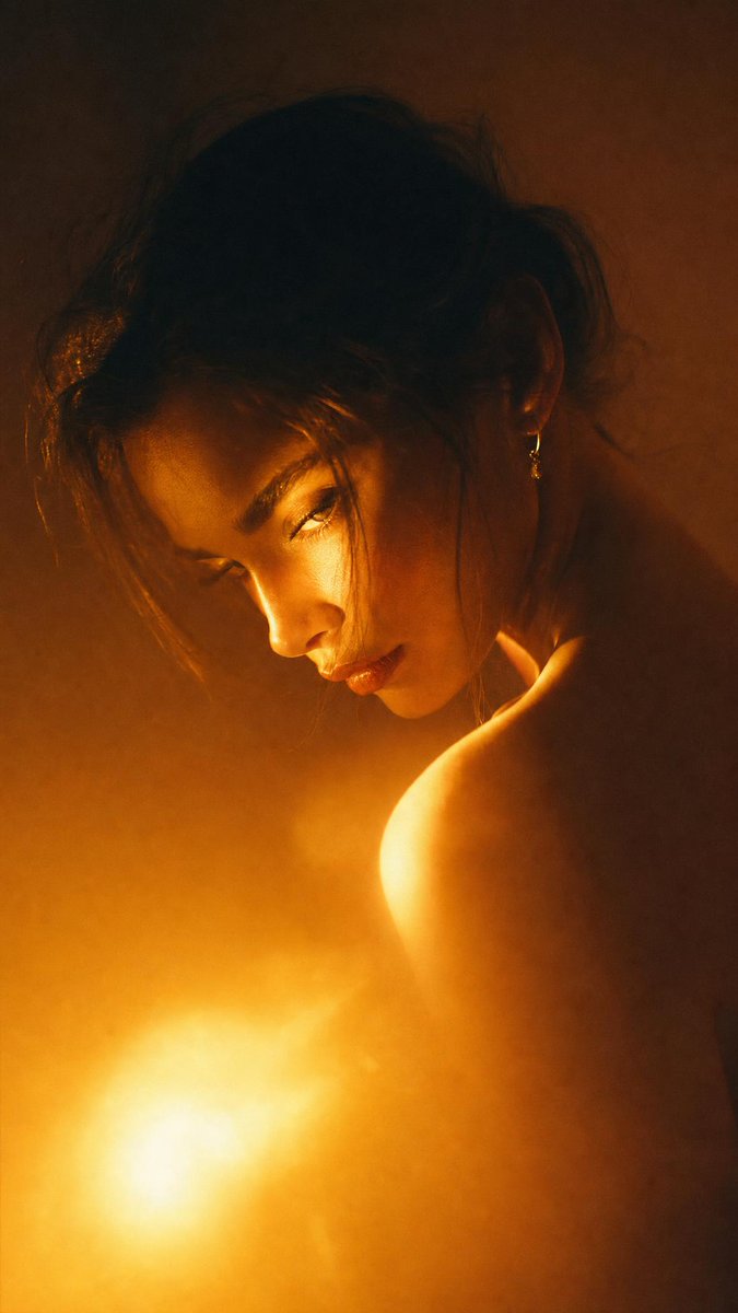 Dramatic close-up portrait with warm colored lighting, a ... - alternate