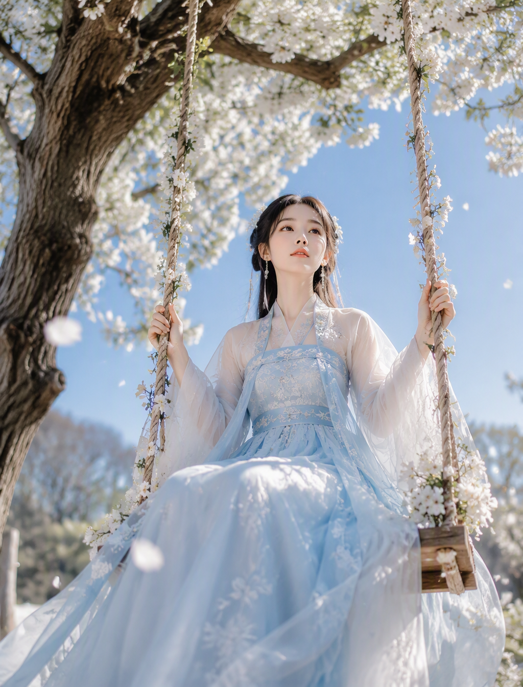 A young woman in flowing pale blue-and-white hanfu sits o...
