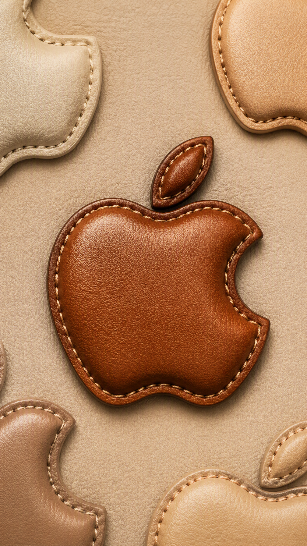 A 3D embossed stitched leather Apple logo in warm cognac ...