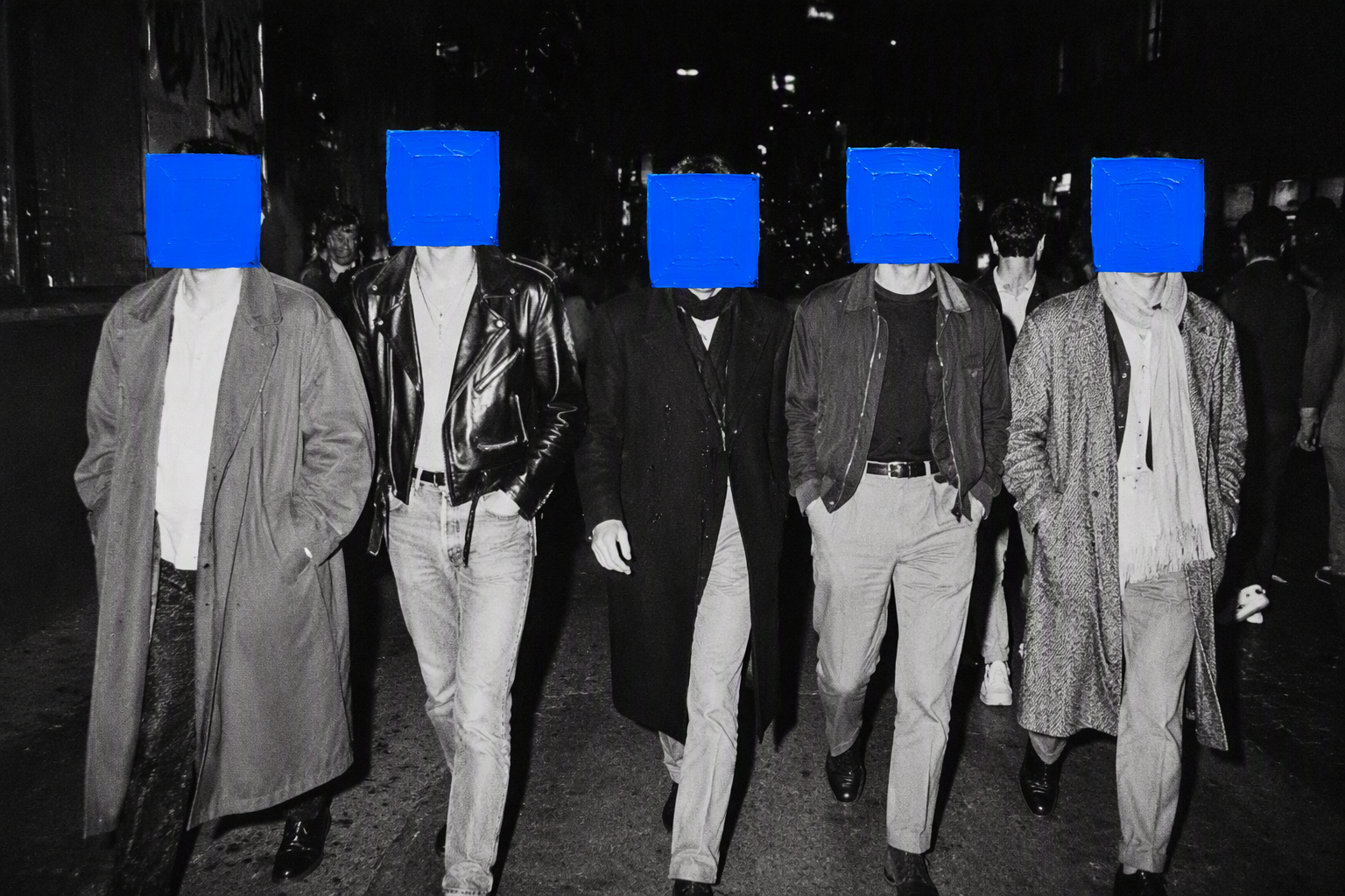 A black and white analog night street photograph set in a...