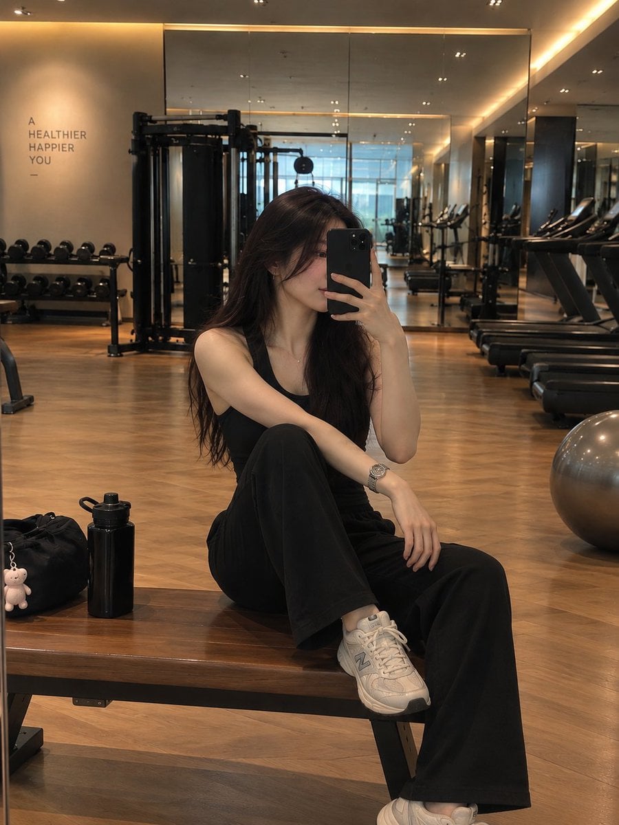 A stylish young woman taking a mirror selfie in a modern ... - alternate