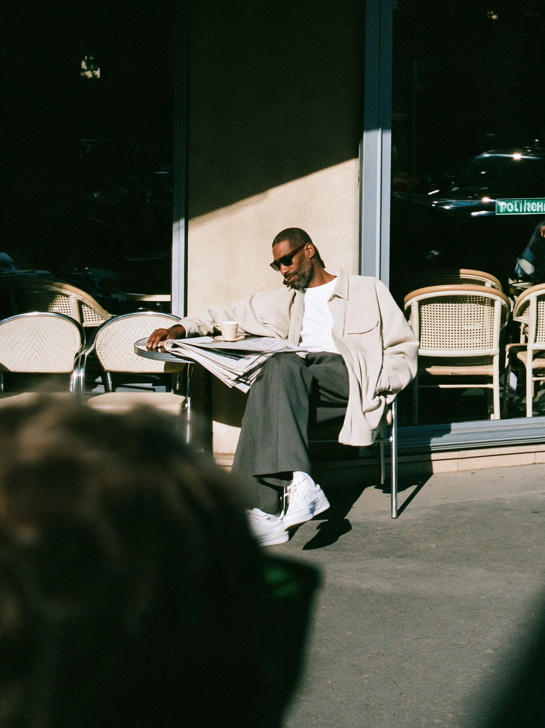 candid street photograph, Black man in his thirties sitti... - alternate