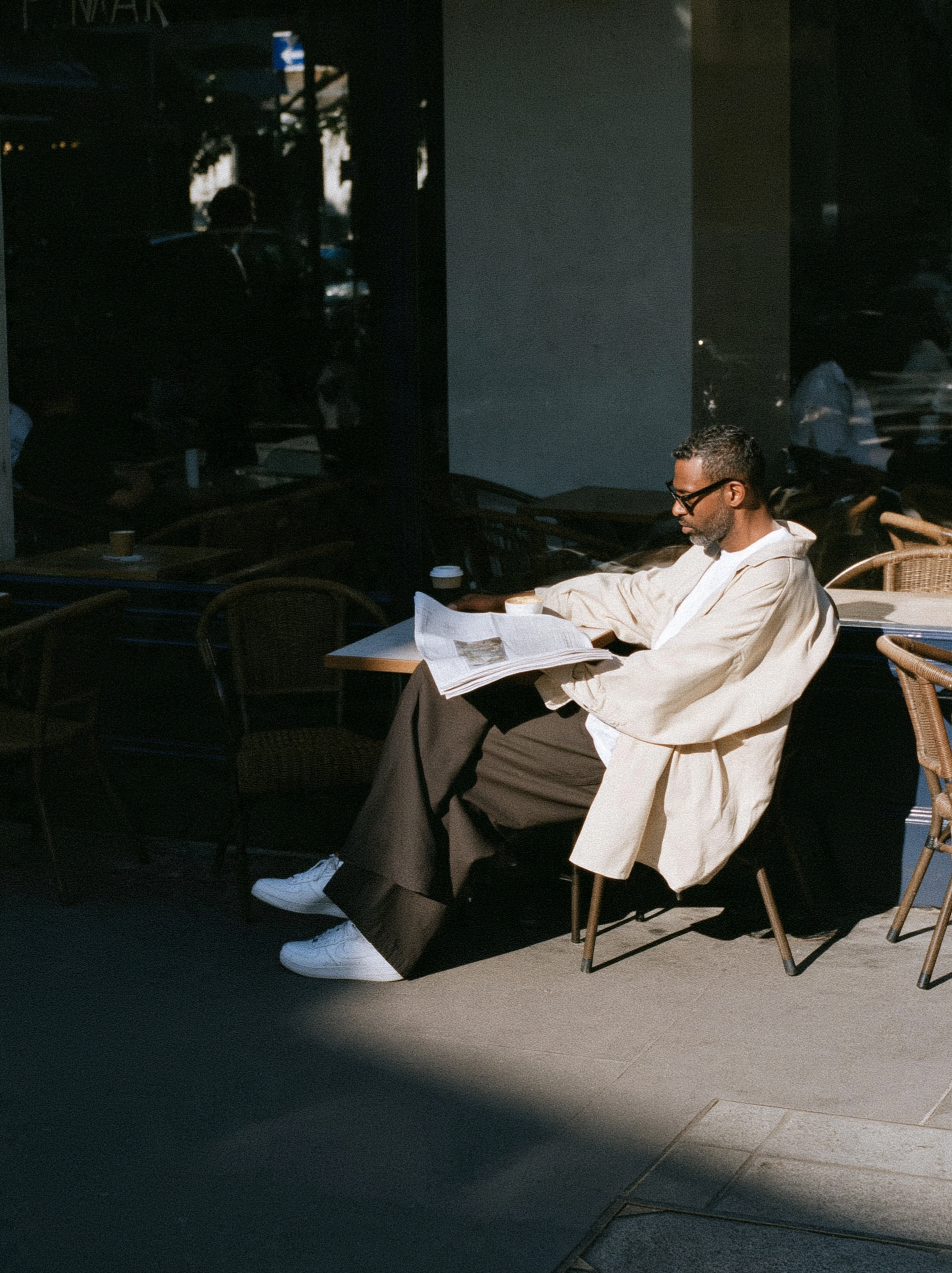 candid street photograph, Black man in his thirties sitti... - alternate