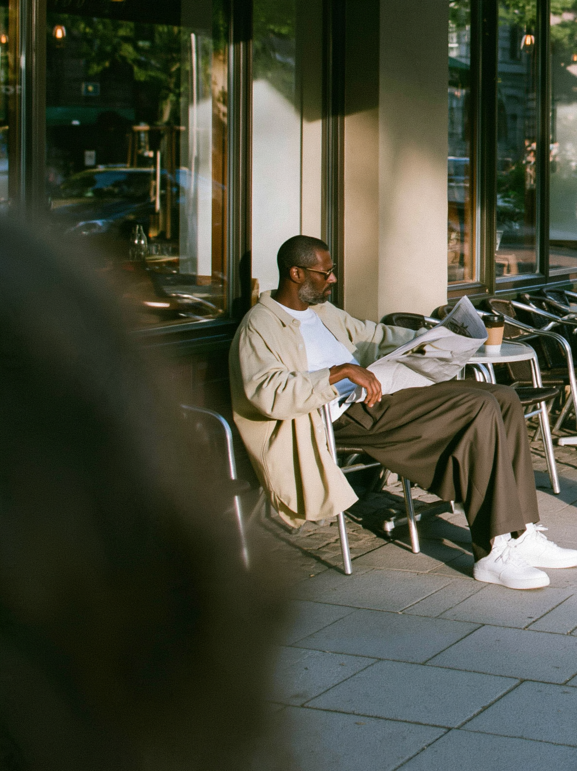 candid street photograph, Black man in his thirties sitti... - alternate