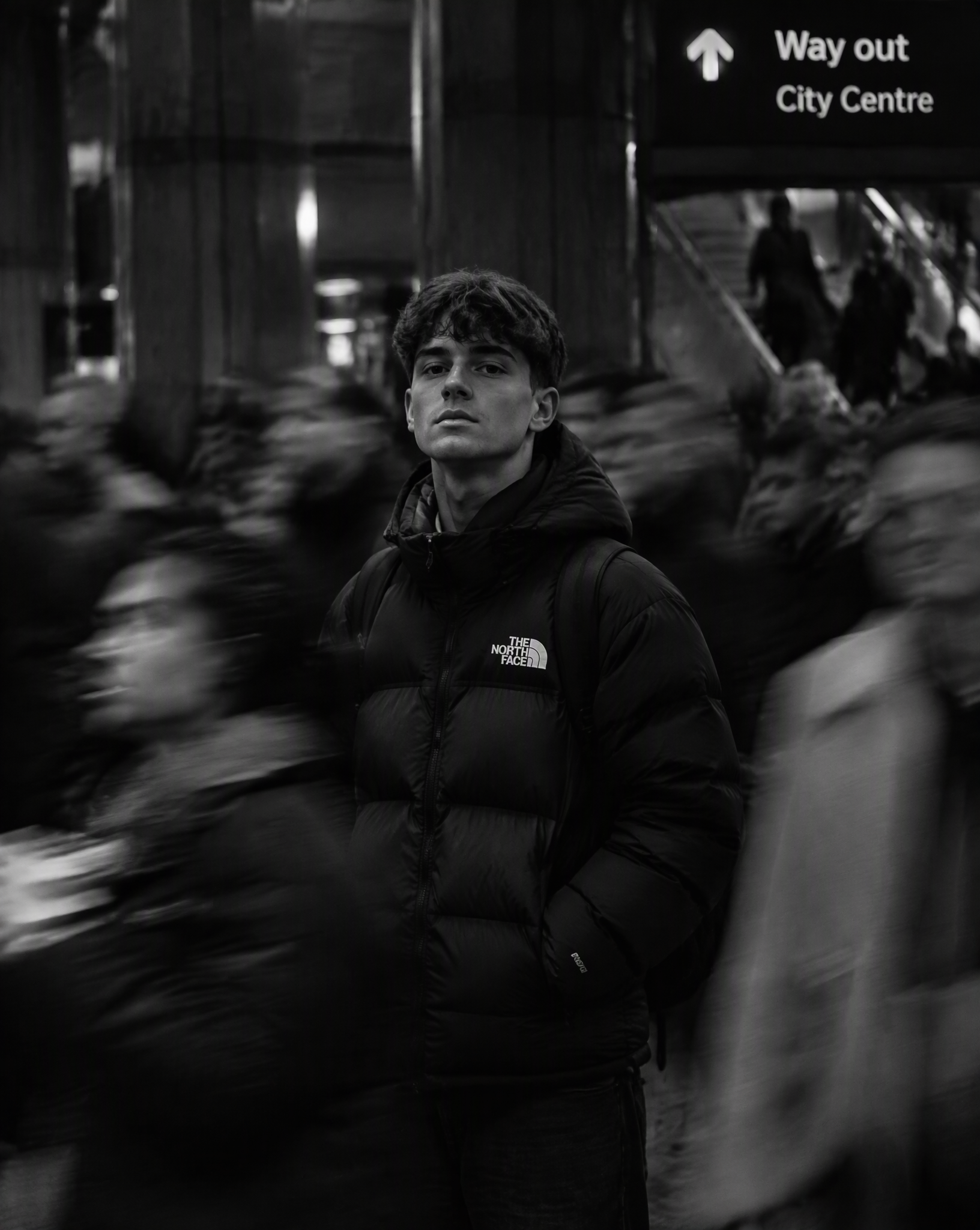 Black-and-white cinematic portrait of a young person in a...